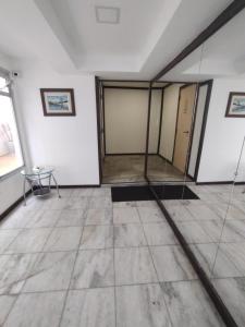 um quarto com paredes brancas e piso em azulejo em Apto Centro Floripa 03 em Florianópolis