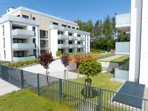 an apartment building with a garden in front of it at Platinium Rewal Aparthotel 17 in Rewal