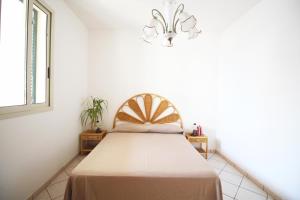 A bed or beds in a room at Casa Simone by RENTHOUSESALENTO