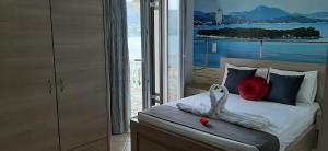 a bedroom with a bed with a view of the ocean at Blue Bay Apartments in Syvota +47 photos