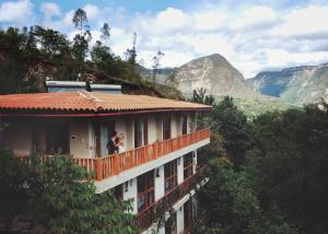 a person standing on a balcony of a building at Gocta Miradors in Cocachimba