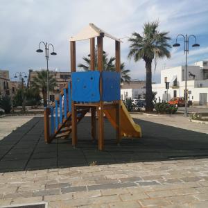 plac zabaw z 2 niebieskimi krzesłami i zjeżdżalnią w obiekcie Casa vacanza da Samuele w mieście San Vito lo Capo