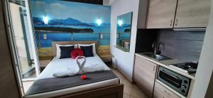 a small kitchen with a bed in a small room at Blue Bay Apartments in Syvota