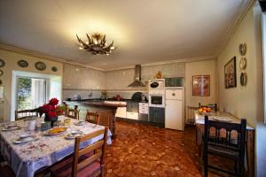 a kitchen with a table and chairs and a dining room at La Cochera de Somao, casona de tipología indiana in Somado +19 photos