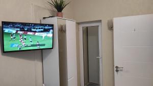 a flat screen tv hanging on a wall at Burgas Central-Sheynovo in Burgas City