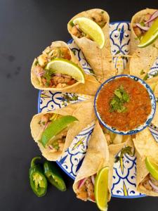 a blue and white plate with tacos and a bowl of salsa at Roatan Yacht Club and Dive Center in Roatan