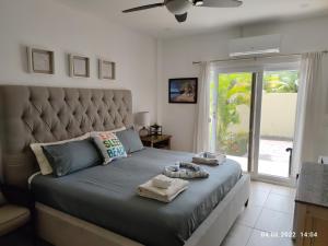 a bedroom with a large bed with a large headboard at Las Palmas - New Horizon in Dixon Cove