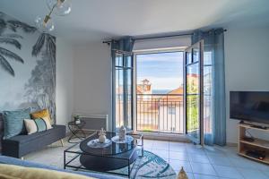 a living room with a couch and a large window at Down Center - Incroyable vue mer proche plage in Arcachon