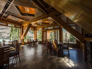 a dining room with wooden tables and chairs at Famree Resort Hunza in Hunza Valley