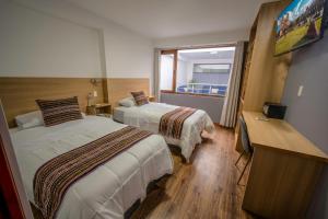 Katil atau katil-katil dalam bilik di Ayni Cusco Hotel