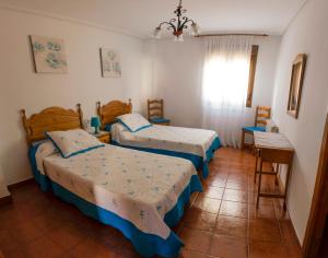 A bed or beds in a room at Apartamentos Rurales El Prado