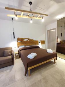 a bedroom with a large bed and a couch at B&B San Vito in Tricase