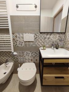 a bathroom with a toilet and a sink and a mirror at B&B San Vito in Tricase +59 photos