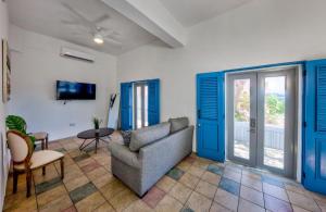 a living room with blue doors and a couch at Casa Pelayo in San Juan