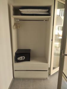 a white refrigerator with its door open with a drawer at Ninfea Tropea City Rooms in Tropea