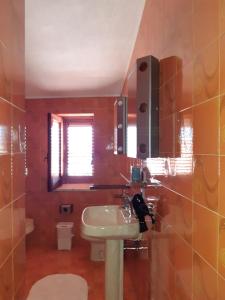 a bathroom with a sink and a toilet at Casa vacanze Antolia in Abatemarco +42 photos