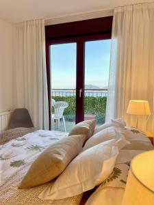 a bedroom with a bed with a view of the ocean at The Cliffs - The Look Seiramar in Viveiro