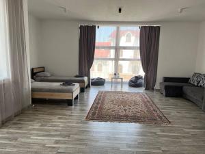 a living room with a couch and a rug at Апартаменты Центр Трускавец in Truskavets