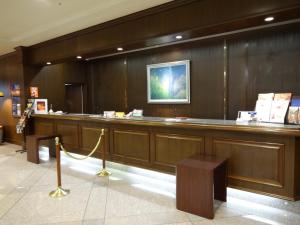 a lobby with a long bar with a yellow rope at Hotel Higashinihon Utsunomiya in Utsunomiya