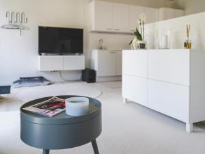 a living room with a table and a tv at Ferienwohung Tennengau mit Parkplatz in Golling an der Salzach