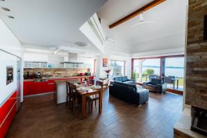 a kitchen and living room with a table and chairs at Balaton View Apartment in Balatonboglár