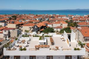 an aerial view of a city with buildings and the ocean at Palm Suites in Pefkochori
