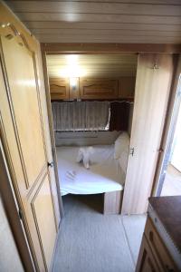 a small room with a bed in an rv at Каравани на плаж Златна Рибка Созопол in Sozopol
