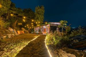 a string of lights over a dirt road at night at Vista Hostel Jeolikote, Nainital in Patwa Dunga