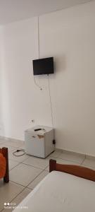 a white room with a tv on the wall at Becici rooms in Becici