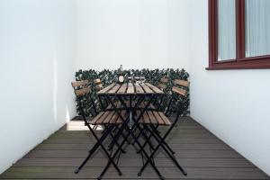 a table and chairs on a balcony with a plant at Porto XL in Porto