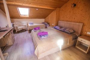 a bedroom with two beds in a wooden room at Dogona Apartment in Tbilisi City