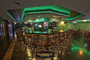 a bar in a restaurant with green lighting at FLORENCIA PLAZA HOTEL in Tegucigalpa