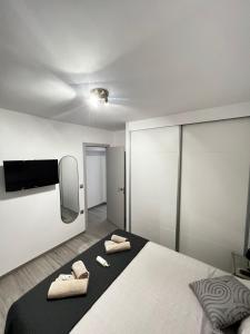 a bedroom with a bed with two towels on it at Apartamento el Cid in Calpe +34 photos