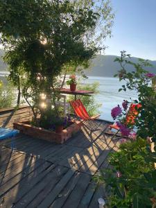 a patio with a table and chairs and the ocean at Rosas Home in Pogradec +28 photos