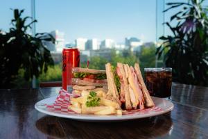 a plate of sandwiches and french fries and a drink at Gamma Ciudad de Mexico Santa Fe in Mexico City
