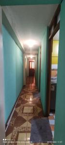 a hallway with blue walls and a tile floor at Anacondor Guests House in Cusco