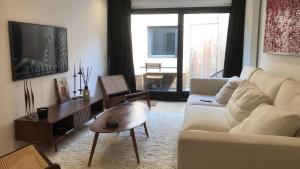 sala de estar con sofá blanco y mesa en Semarane, en Knokke-Heist