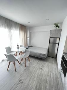a living room with a bed and a table and chairs at Apartamento el Cid in Calpe