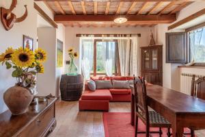 a living room with a couch and a table at Podere le Serre in Cingoli