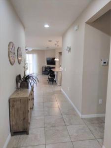 a room with a hallway with a table and a living room at CozyKey Vacation Rentals - Crystal Cove in Kissimmee