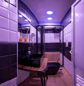 a bathroom with a black sink and a tub at Taksim Square Hostel in Istanbul