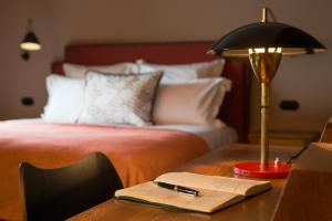 a bedroom with a bed and a desk with a lamp at Valverde Hotel - Relais & Chateaux in Lisbon