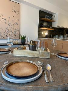 a table with a plate and wine glasses on it at Fiets & Zee - Bike & Sea in Ostend +9 photos