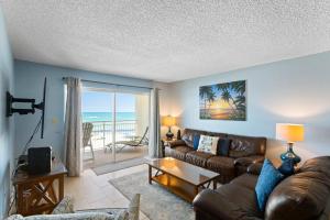a living room with a couch and a table at 311 Madeira Norte Condo in St. Pete Beach