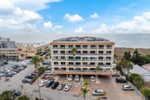 a large building with a parking lot next to the ocean at 311 Madeira Norte Condo in St. Pete Beach