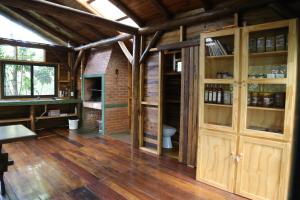 a room with wooden cabinets and a toilet in a building at Piel de Timbó in Aristóbulo del Valle