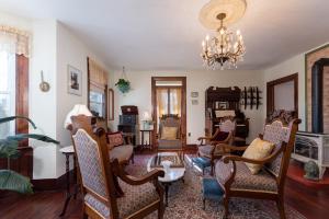 a living room with chairs and a chandelier at Saratoga Farmstead B&B in Saratoga Springs