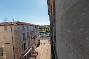 a view of a street between two buildings at Cosy Apparts Saintes in Saintes