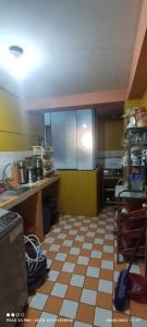 a kitchen with a checkered floor in a kitchen at Anacondor Guests House in Cusco