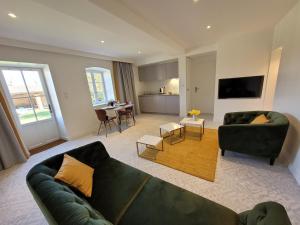 a living room with a couch and a table at LODGES EN PIERRES DOREES in Saint-Germain-Nuelles